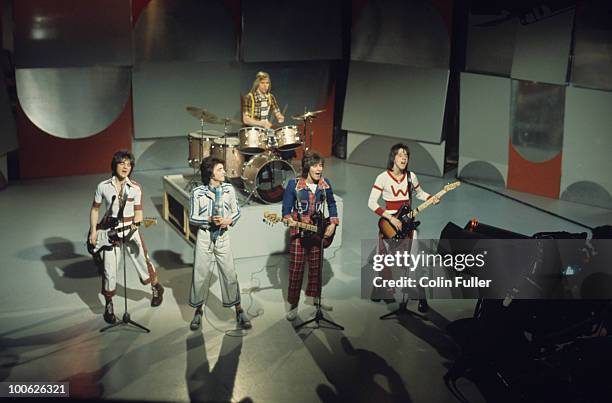 Eric Faulkner, Les McKeown, Derek Longmuir, Alan Longmuir and Stuart Wood of the Bay City Rollers perform on a BBC television show in 1975.