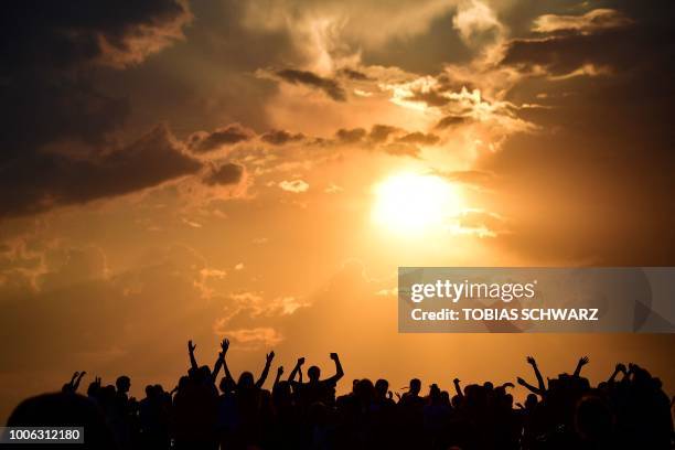 People gather as they wait for the sun to go down and the appearance of the 'Blood moon' in Berlin on July 27, 2018. The 'Blood moon' total lunar...