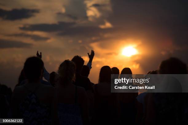 People gather in the sunset to await the rising of the blood Moon in on July 27, 2018 in Berlin, Germany. The period of totality during this eclipse,...