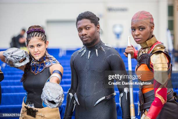 Fans dressed as characters from Marvel's Black Panther movie attend Comic-Con International on July 20, 2018 in San Diego, California.