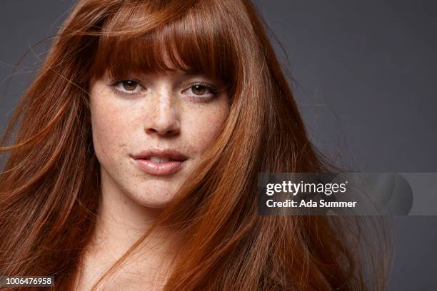 smiling woman with windblown red long hair - thick white women stock pictures, royalty-free photos & images