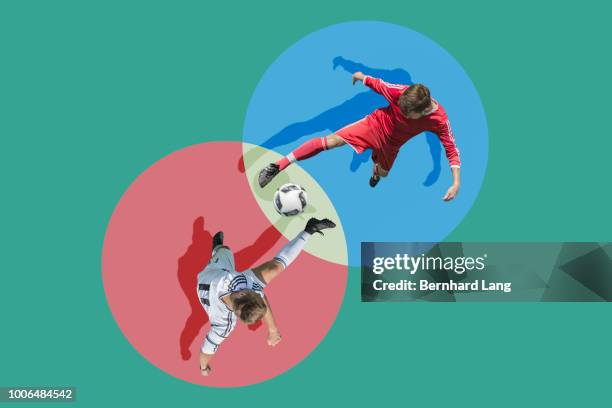 two soccer players fighting for ball, aerial view - treten stock-fotos und bilder