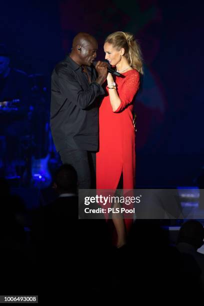 Seal performs on stage with Adriana Karembeu during the 70th Monaco Red Cross Ball Gala on July 27, 2018 in Monte-Carlo, Monaco.