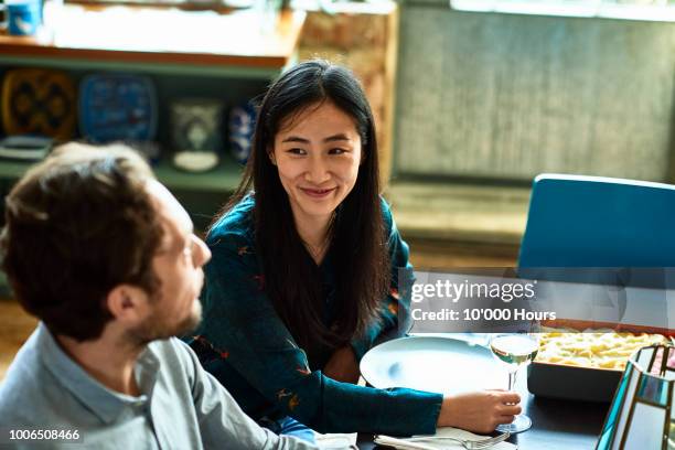 cheerful couple at dinner table talking and smiling - bohemia czech republic fotografías e imágenes de stock