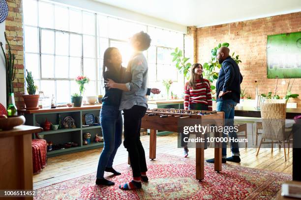 couple dancing and laughing with two friends in apartment - london game 2018 stock pictures, royalty-free photos & images