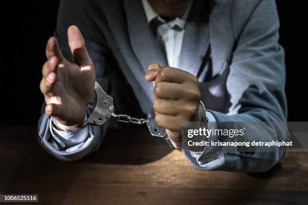 businessmen arrested,businessman with handcuffs - neckwear fotografías e imágenes de stock