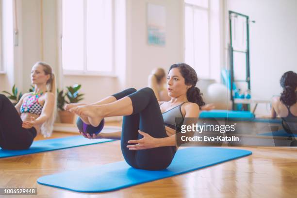 women in the fitness center - mat stock pictures, royalty-free photos & images