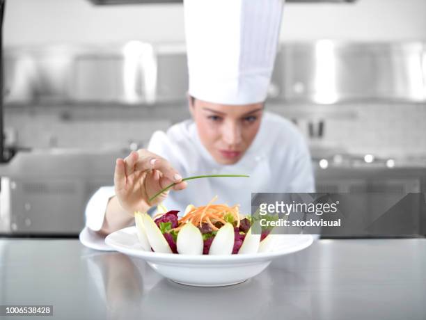 chef completing salad - chef finishing stock pictures, royalty-free photos & images