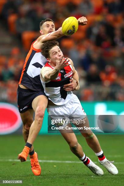 Brett Deledio of the Giants spoils the ball during the round 19 AFL match between the Greater Western Sydney Giants and the St Kilda Saints at...