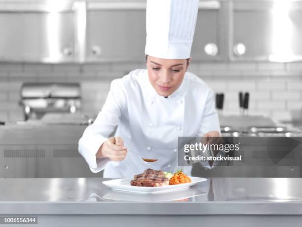 female chef preparing steak plate - front of restaurant stock pictures, royalty-free photos & images