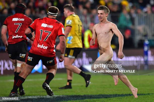 Graphic content / A streaker runs across the field during the Super Rugby semi-final match between New Zealand's Canterbury Crusaders and Wellington...