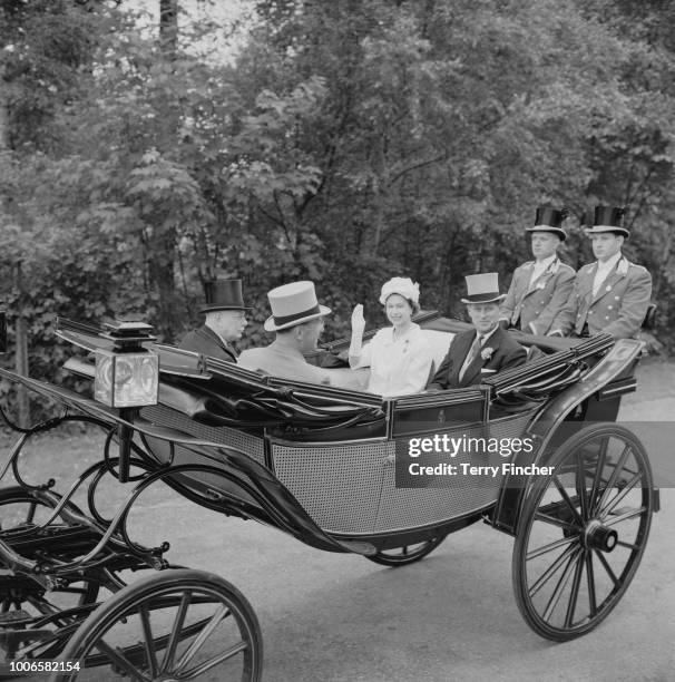 Queen Elizabeth II and Prince Philip, Duke of Edinburgh ride together in a royal carriage to Ascot Racecourse during Royal Ascot week in Berkshire,...