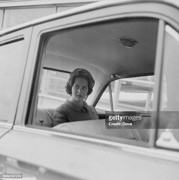 Princess Benedikte of Denmark pictured seated in the rear seat of a car at London Airport on 14th June 1965.
