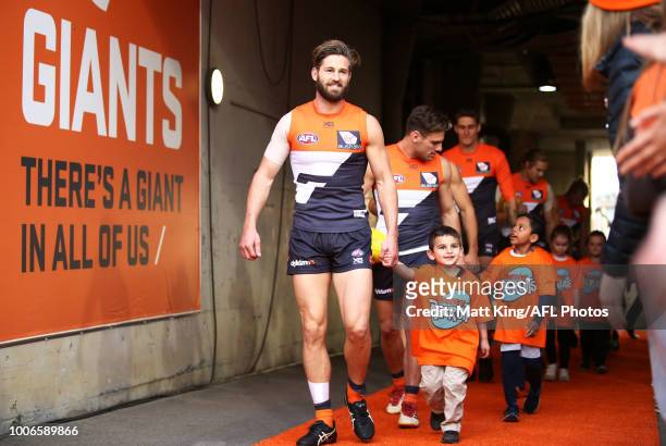 Callan Ward of the Giants leads the Giants through the race during the round 19 AFL match between the Greater Western Sydney Giants and the St Kilda...