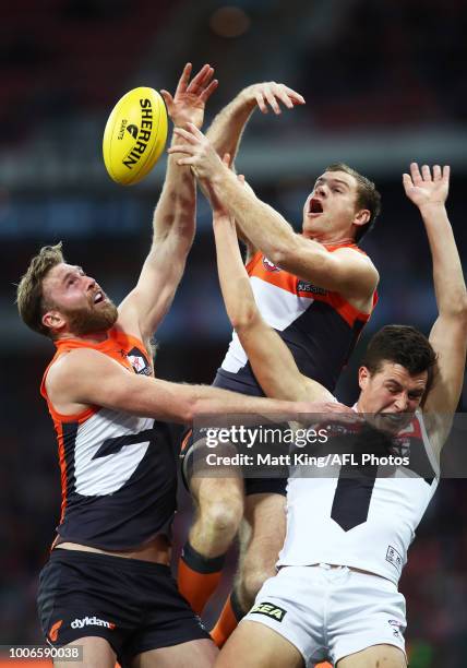 Dawson Simpson and Heath Shaw of the Giants competes for the ball against Rowan Marshall of the Saints during the round 19 AFL match between the...