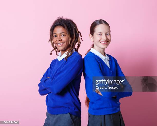 happy students standing together - african american school uniform stock pictures, royalty-free photos & images