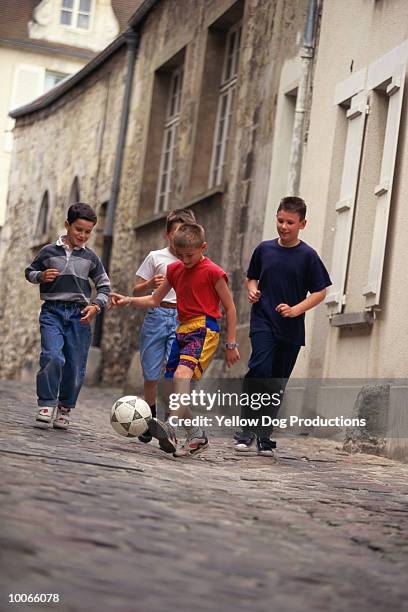 boys playing soccer in senlis, france - oise stockfoto's en -beelden