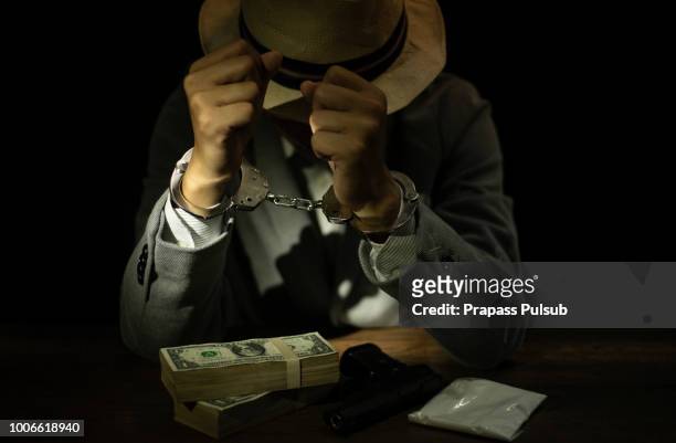 suspect or criminal man with handcuffs being interviewed by detectives in interrogation room a suspected drug trafficking - cocaine, heroin, spice, marijuana, and etc - marijuana arrest stock pictures, royalty-free photos & images