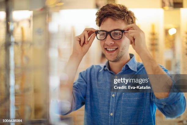in the optics store - try on stock pictures, royalty-free photos & images