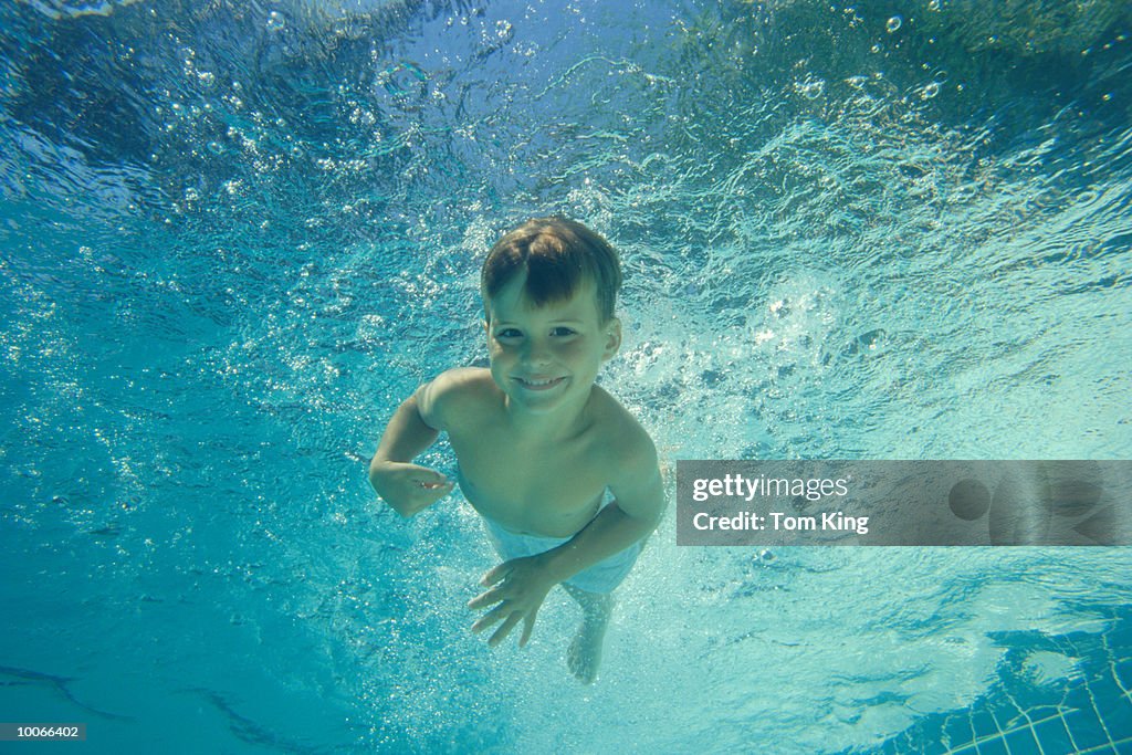 YOUNG BOY SWIMMING FROM UNDERWATER