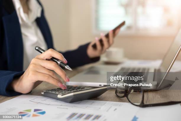 close up of female accountant or banker making calculations. savings, finances and economy concept - redovisning bildbanksfoton och bilder