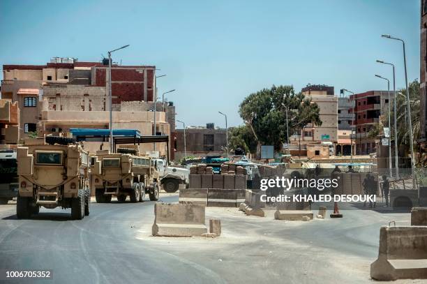 Picture taken on July 26, 2018 shows Egyptian policemen driving on a road leading to the North Sinai provincial capital of El-Arish. - With fruit and...