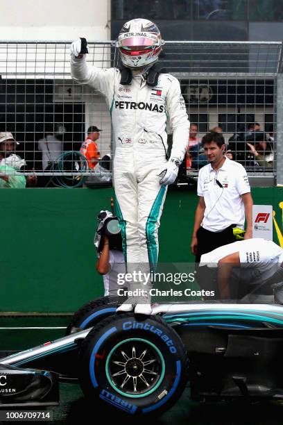 Pole position qualifier Lewis Hamilton of Great Britain and Mercedes GP celebrates in parc ferme during qualifying for the Formula One Grand Prix of...