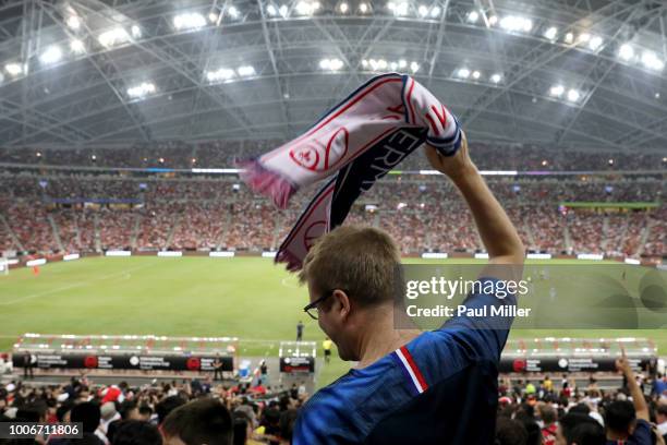 Paris Saint-Germain fan cheers during the International Champions Cup match between Arsenal and Paris Saint Germain at the National Stadium on July...