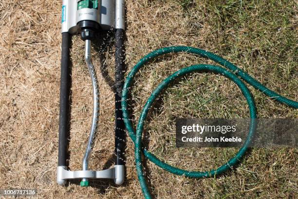 Water sprays from a sprinkler in a garden on July 24, 2018 in Leigh On Sea, England. Seven million residents in the north west of England are...