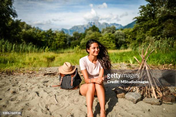 smiling woman text messaging. - bonfire beach stock pictures, royalty-free photos & images