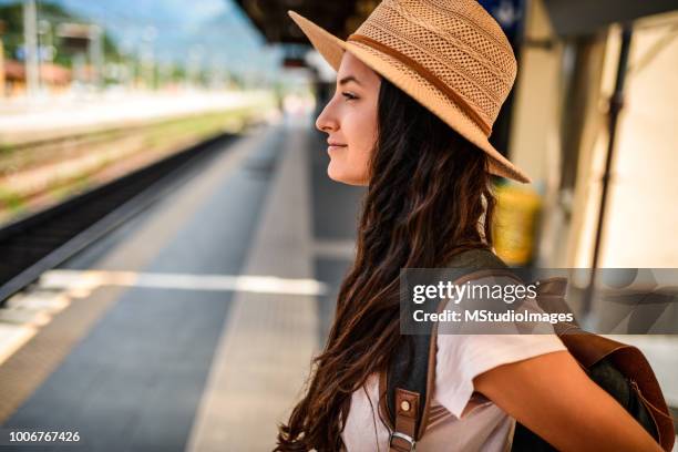 profile of smiling traveler waiting for a train. - train france stock pictures, royalty-free photos & images