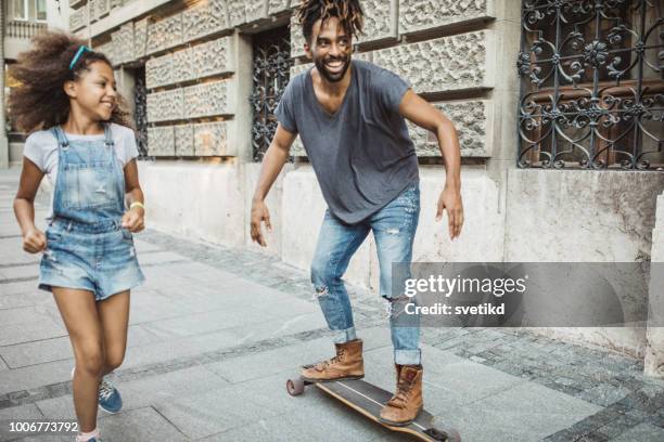father spending great time with daughter - father longboard stock pictures, royalty-free photos & images