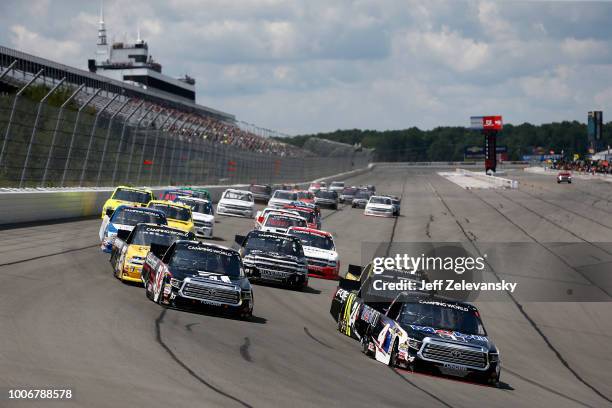 Todd Gilliland, driver of the Mobil 1 Toyota, and Kyle Busch, driver of the Cessna Toyota, lead the field into turn one during the NASCAR Camping...