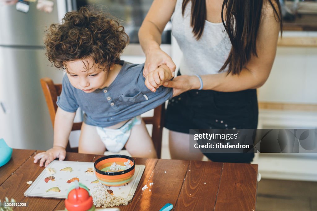 Mother make the mess after toddler lunch