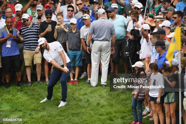 Dustin Johnson plays his shot out of the rough on the ninth hole during the third round at the RBC Canadian Open at Glen Abbey Golf Club on July 28,...