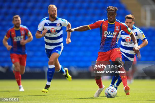 Wilfried Zaha of Crystal Palace in action with Liam Kelly and David Meyler of Reading during the Pre-Season Friendly between Reading and Crystal...