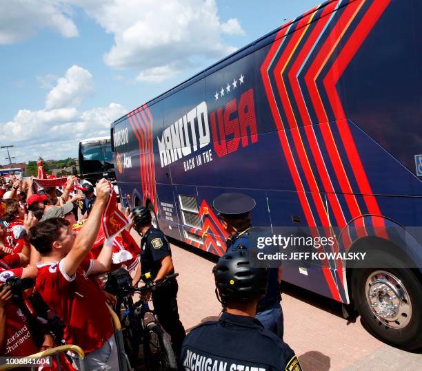 Liverpool FC fans shout as team busses arrive before the match against Manchester United in the 2018 International Champions Cup at Michigan Stadium...