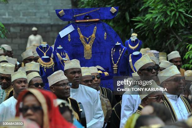 Family and representatives of the grooms family arrive bearing golden jewelry for the bride at a traditional wedding ceremony in Moroni July 28...