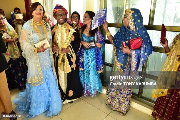 The newly weds are serenedaded by guests as they emerge together during a traditional wedding ceremony at the home of the bride in Moroni July 28...