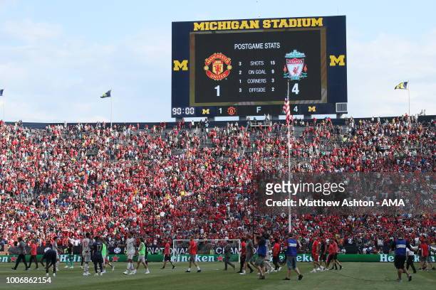 The two teams leave the field with the stadium scoreboard showing the final score of Manchester United 1 - 4 Liverpool in the International Champions...