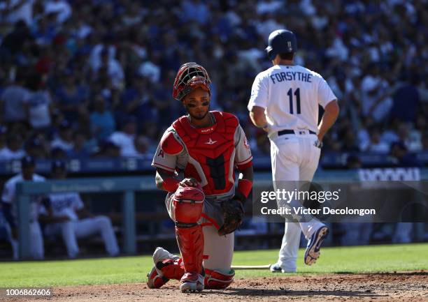 Catcher Martin Maldonado of the Los Angeles Angels of Anaheim looks on after Logan Forsythe of the Los Angeles Dodgers scored in the second inning...