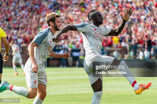 Adam Lallana and Sadio Mane of Liverpool celebrate after Mane scored the opening goal during first half against the Manchester United of the...