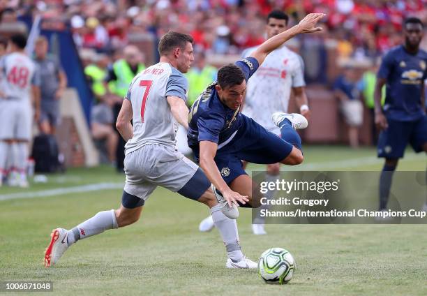 Matteo Darmian of Manchester United gets tripped up by James Milner of Liverpool in the second half during the International Champions Cup 2018 match...