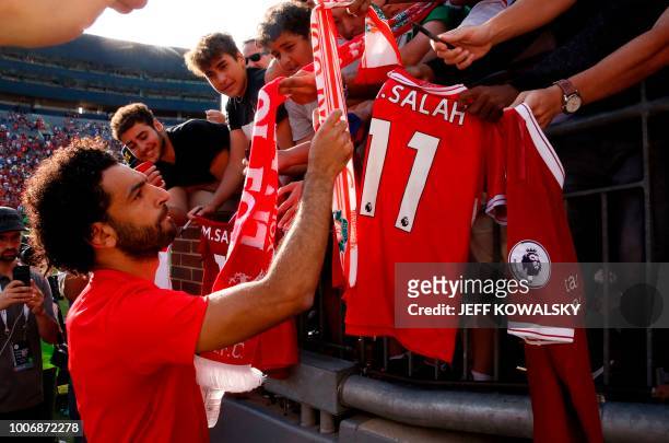 Mohamed Salah signs autographs after their game against Manchester United during their 2018 International Champions Cup match at Michigan Stadium in...