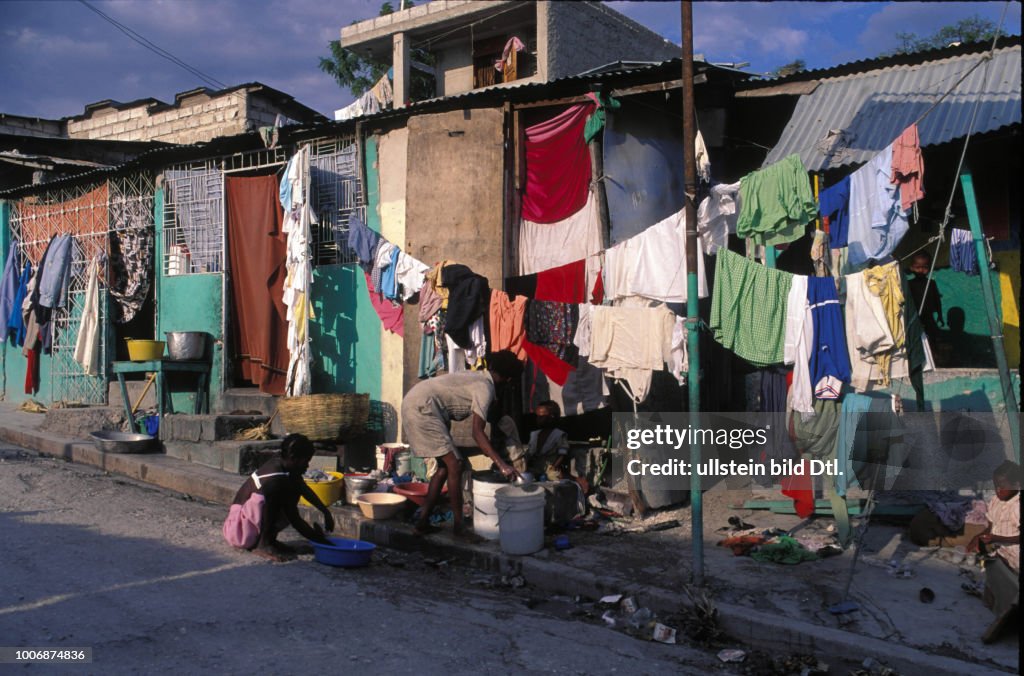 SLUMS HAITI Port au Prince Site Soleil Washing laundry in the SLUMS HAITI Port au Prince Site Soleil Washing laundry in the
