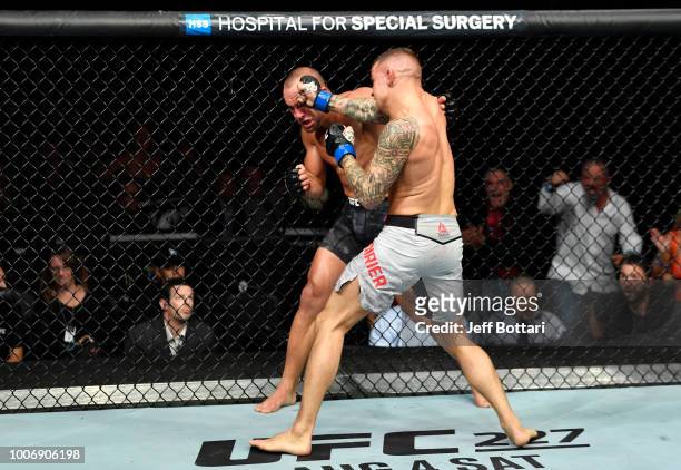 Dustin Poirier punches Eddie Alvarez in their lightweight bout during the UFC Fight Night event at Scotiabank Saddledome on July 28, 2018 in Calgary,...
