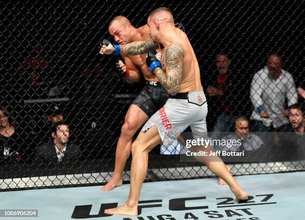 Dustin Poirier punches Eddie Alvarez in their lightweight bout during the UFC Fight Night event at Scotiabank Saddledome on July 28, 2018 in Calgary,...