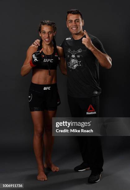 Joanna Jedrzejczyk of Poland poses for a portrait backstage with her coach after her victory over Tecia Torres during the UFC Fight Night event at...