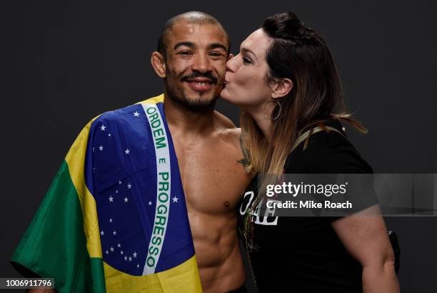 Jose Aldo of Brazil poses for a portrait backstage with his wife Vivianne after his victory over Jeremy Stephens during the UFC Fight Night event at...