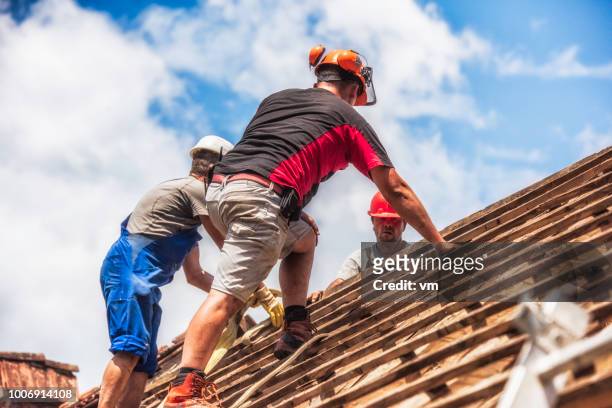 three men working on a roof - roofing contractor stock pictures, royalty-free photos & images